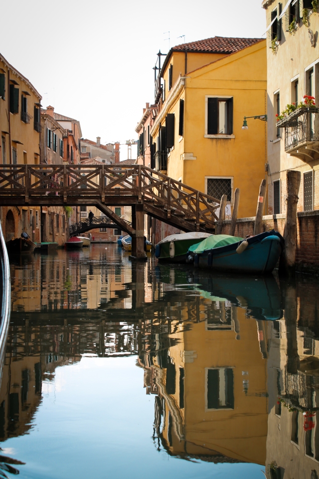 A small wooden bridge over a canal in Venice